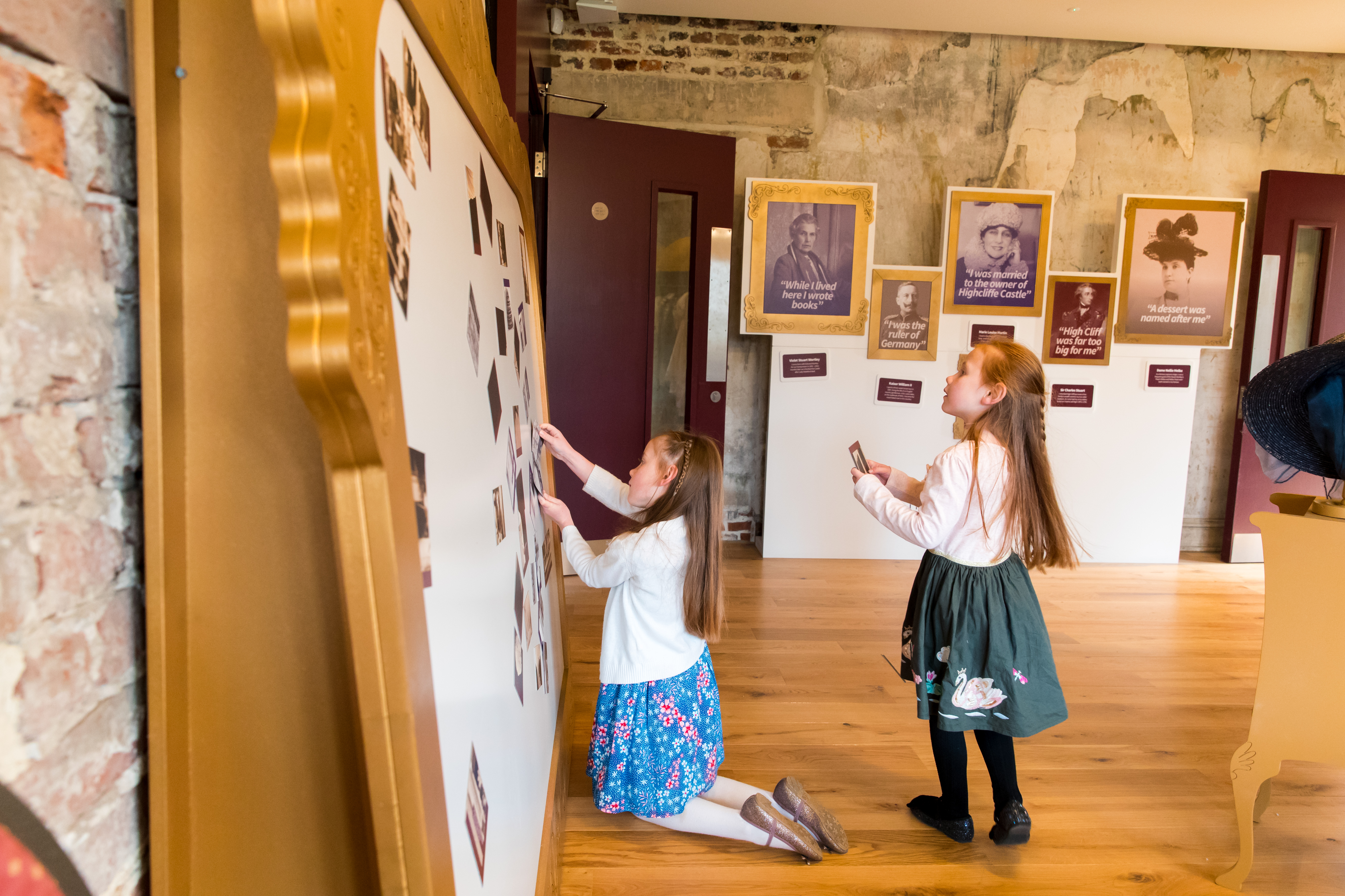 Two young girls playing with the activity wall in the Family Room at Highcliffe Castle