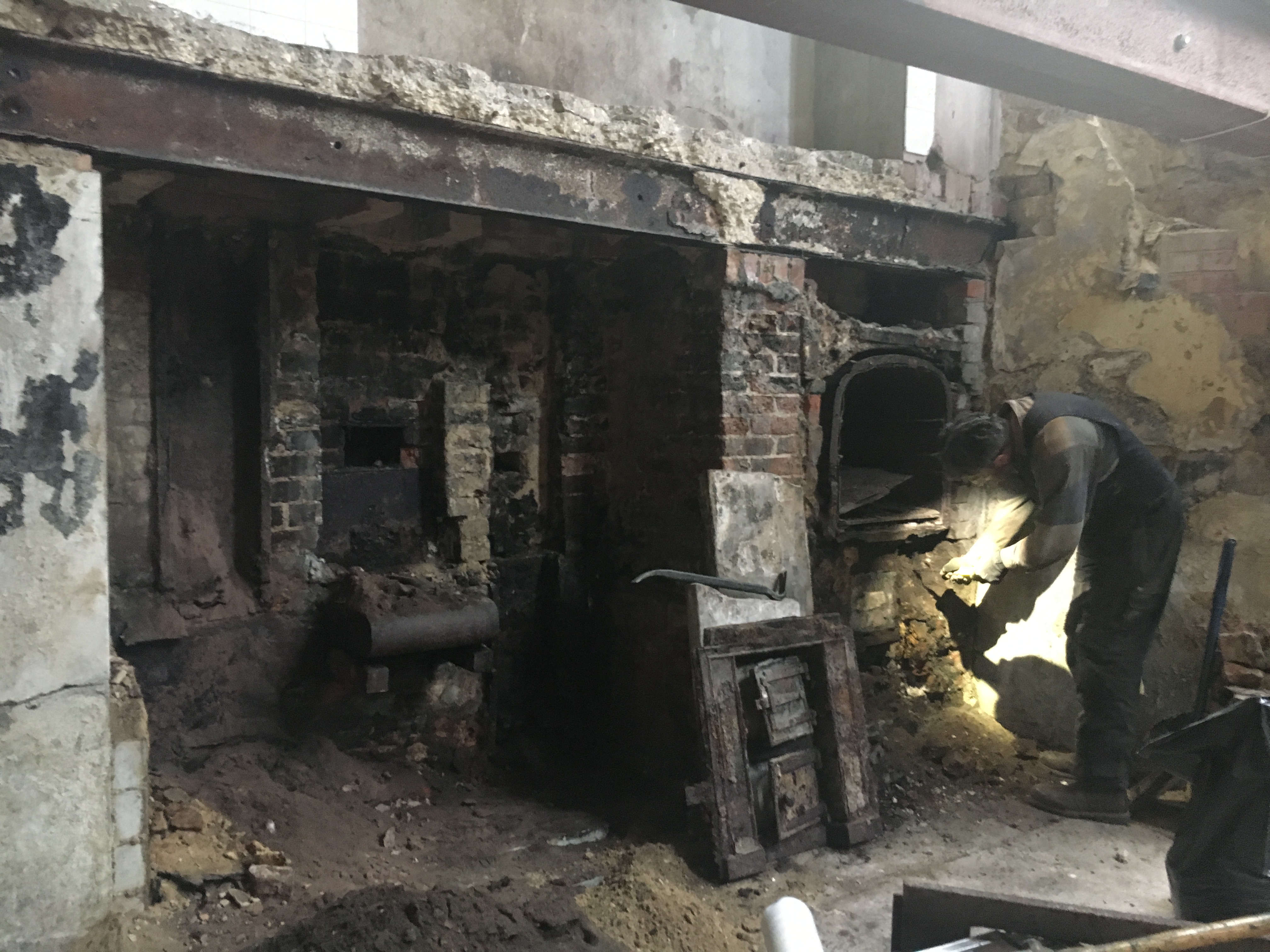Old range stove blackened with age in state of disrepair.