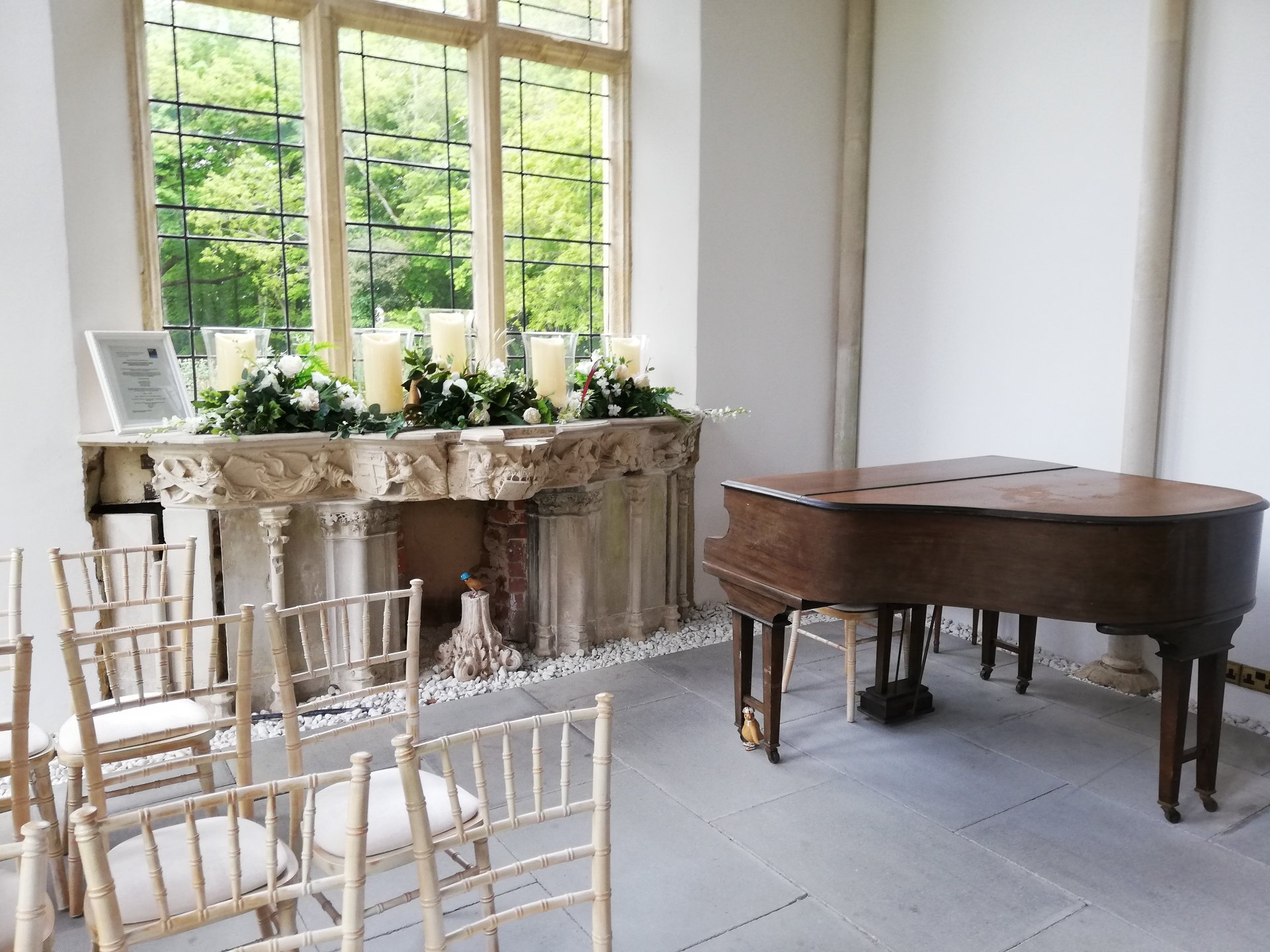 Spot the Duck - all three birds hiding around the piano in the Wintergarden at Highcliffe Castle. There is a big bright window above a stone fireplace.